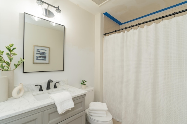 bathroom with vanity, toilet, and curtained shower