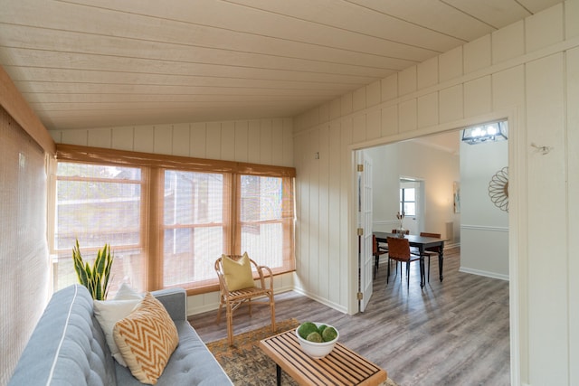 living room with wood ceiling, vaulted ceiling, wooden walls, and hardwood / wood-style floors