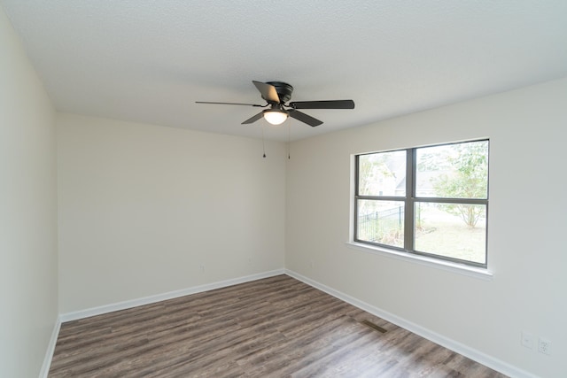 spare room featuring hardwood / wood-style floors and ceiling fan