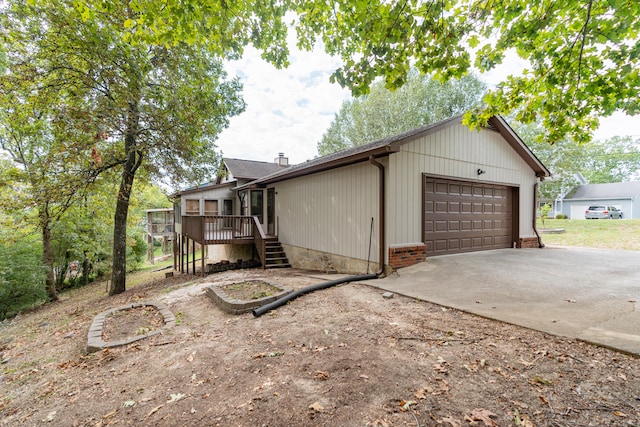 view of home's exterior featuring a wooden deck and a garage