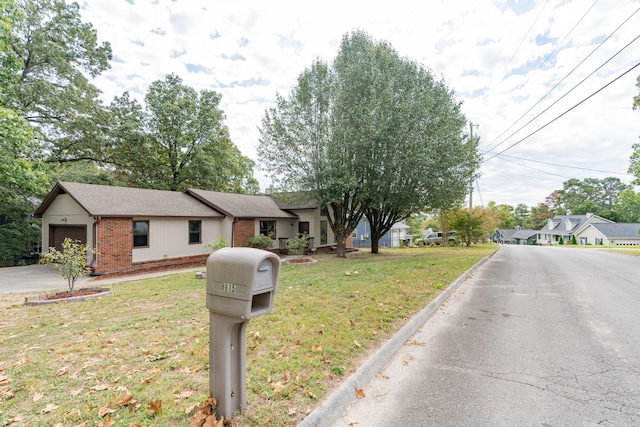 view of front of home featuring a front yard and a garage