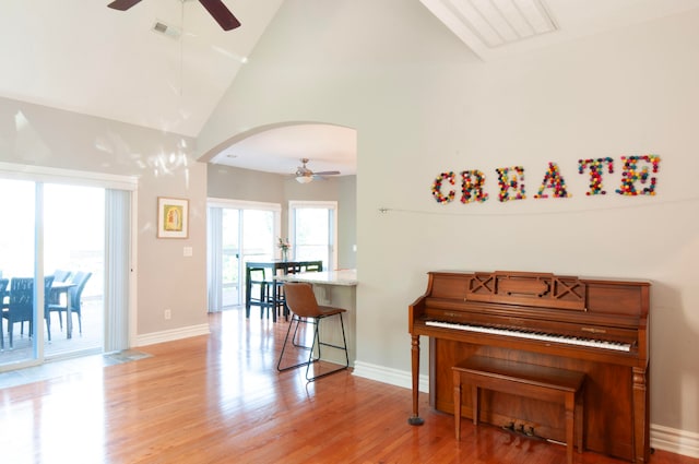 miscellaneous room featuring light hardwood / wood-style floors, high vaulted ceiling, and ceiling fan