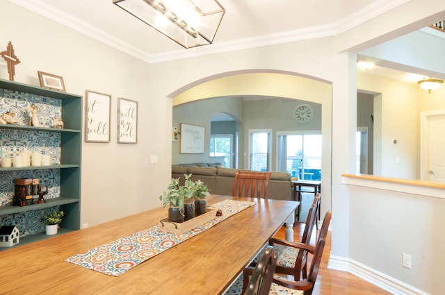 dining area featuring crown molding and wood-type flooring