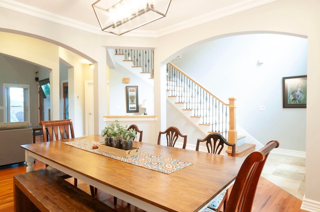 dining space featuring crown molding and light wood-type flooring