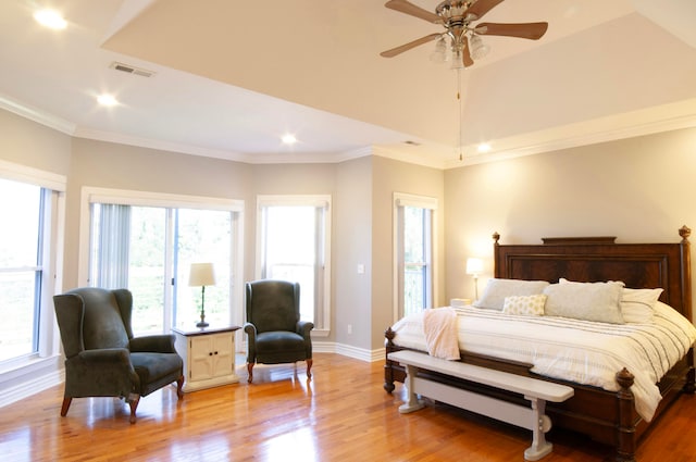 bedroom with hardwood / wood-style floors, crown molding, and ceiling fan