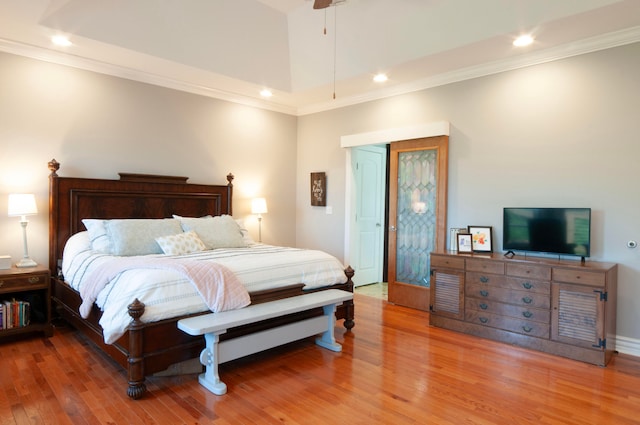 bedroom with ornamental molding, hardwood / wood-style floors, and ceiling fan