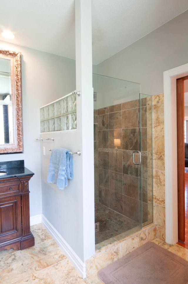 bathroom featuring vanity and a shower with shower door