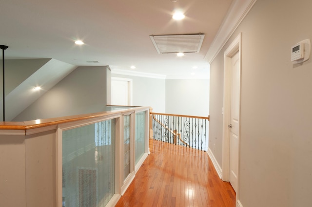 hall with crown molding and light wood-type flooring