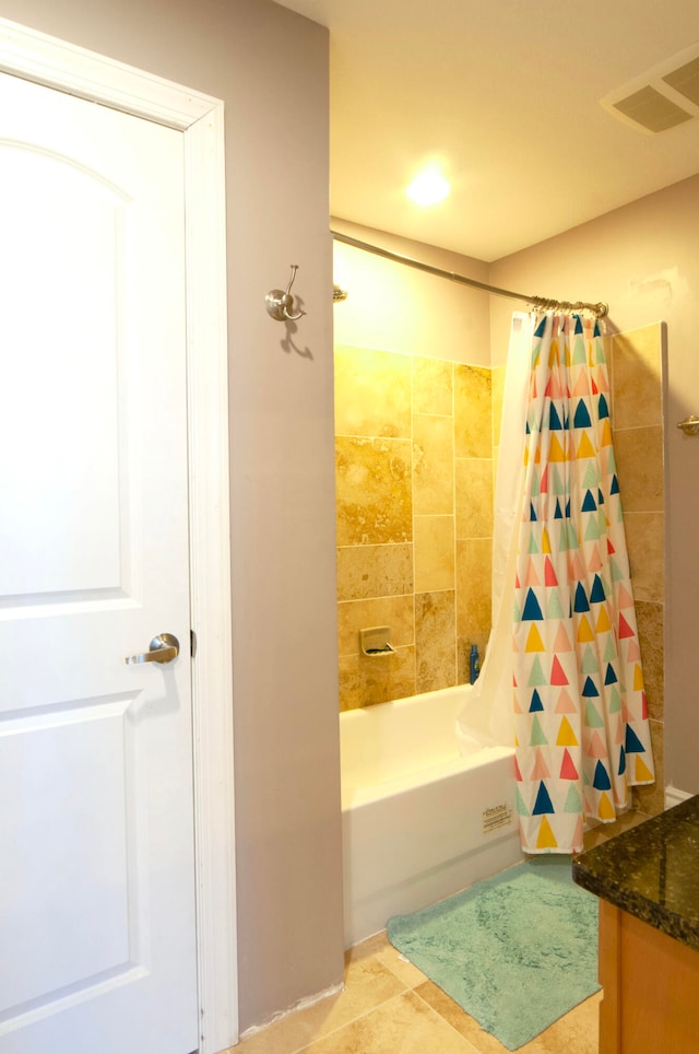 bathroom featuring vanity, tile patterned floors, and shower / bath combo with shower curtain