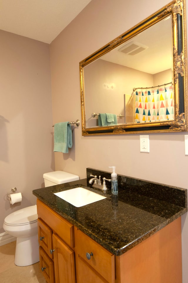 bathroom featuring vanity, a shower with shower curtain, and toilet