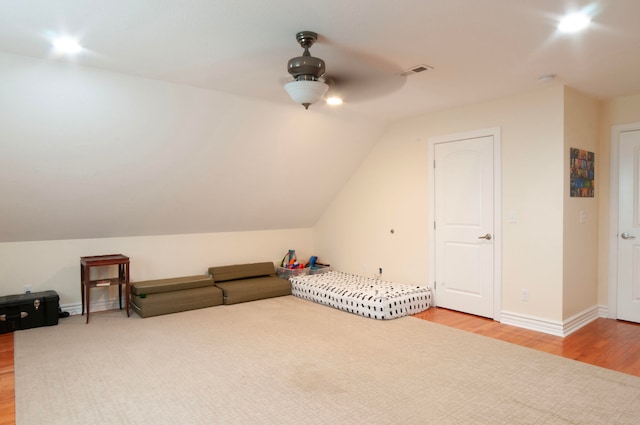 unfurnished bedroom with ceiling fan, hardwood / wood-style flooring, and lofted ceiling