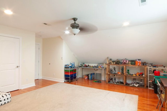 game room with ceiling fan, hardwood / wood-style flooring, and vaulted ceiling