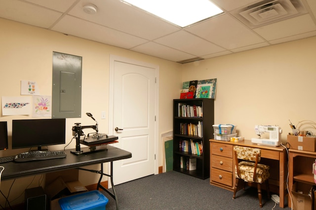 office area with a paneled ceiling, electric panel, and dark carpet