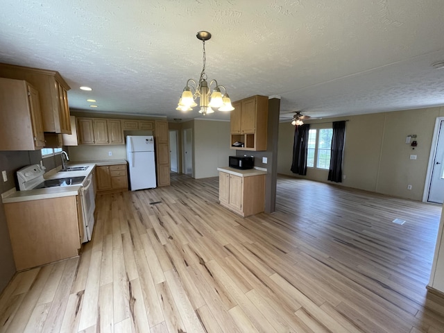 kitchen featuring hanging light fixtures, a textured ceiling, light wood-type flooring, ceiling fan with notable chandelier, and white appliances