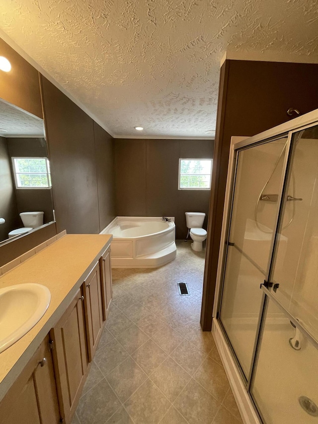 full bathroom featuring vanity, independent shower and bath, a textured ceiling, and toilet