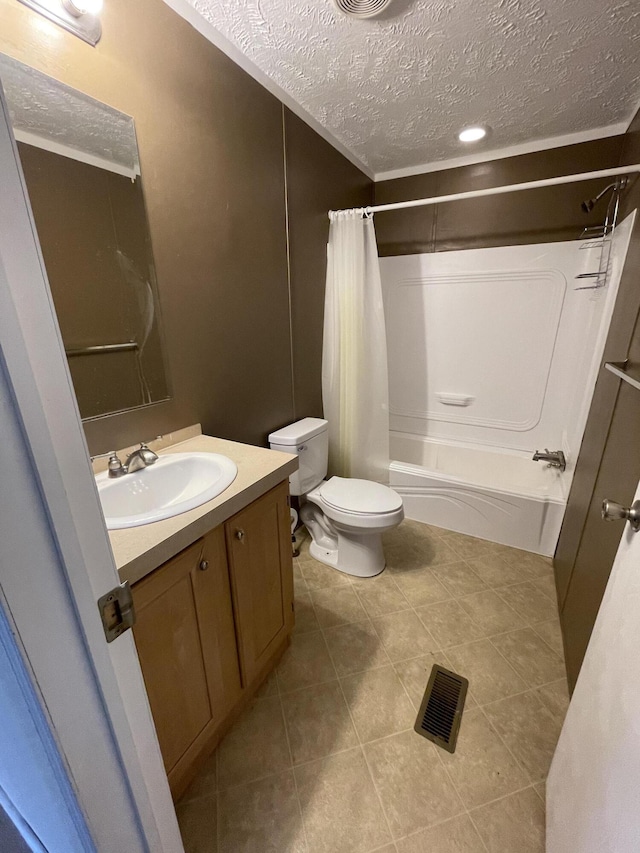 full bathroom with shower / tub combo, a textured ceiling, toilet, tile patterned floors, and vanity