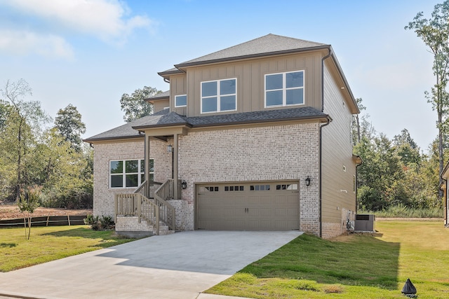 view of front of home with a garage, central air condition unit, and a front yard