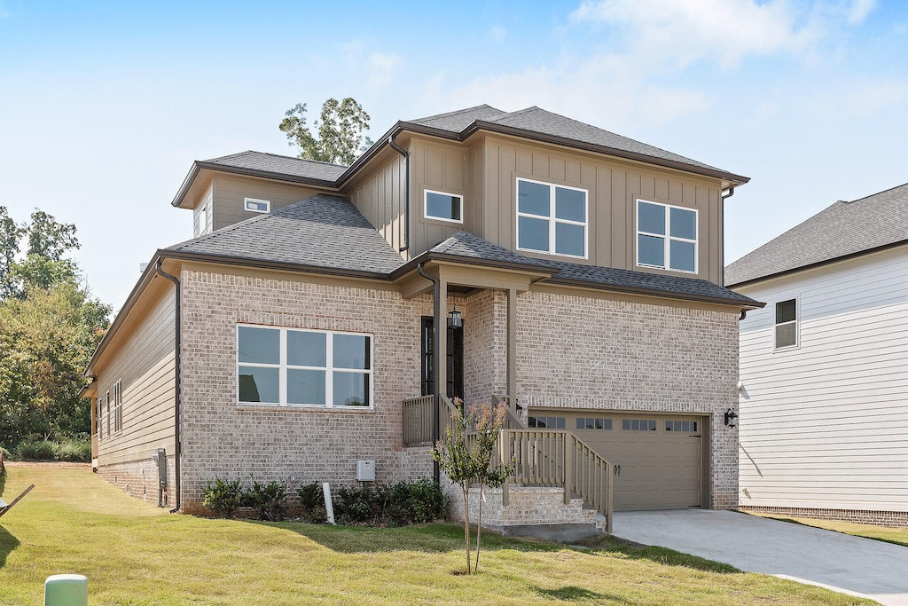 view of front of property featuring a garage and a front lawn