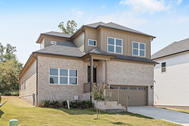 view of front of property featuring a garage and a front lawn