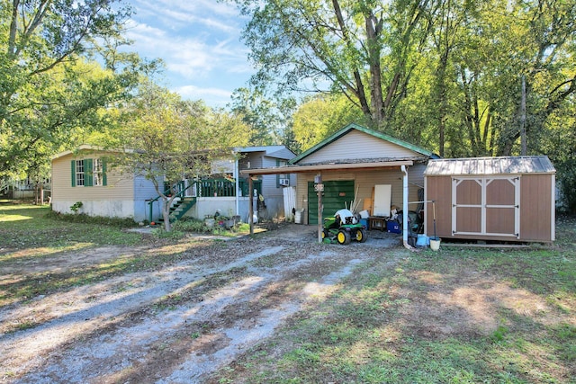 view of front of home featuring a storage unit