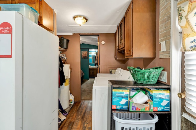 laundry area featuring cabinets, electric water heater, dark wood-type flooring, and separate washer and dryer