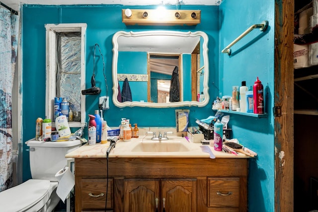 bathroom featuring vanity and toilet