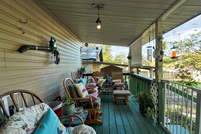 wooden terrace with an outdoor hangout area