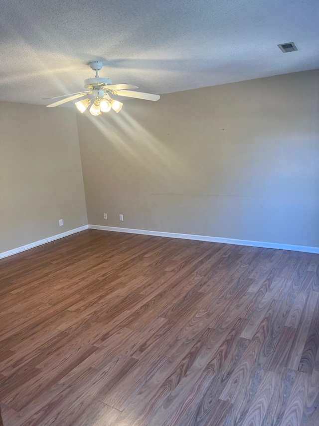 spare room with a textured ceiling, hardwood / wood-style flooring, and ceiling fan