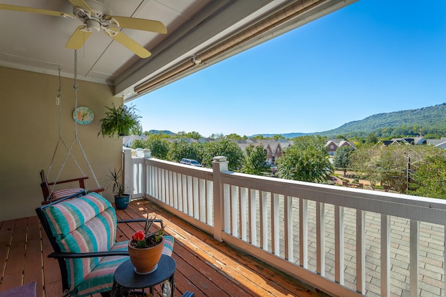 balcony with a mountain view and ceiling fan