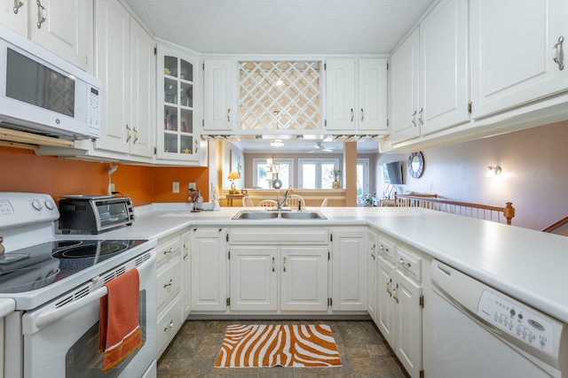 kitchen featuring white appliances, white cabinetry, and sink