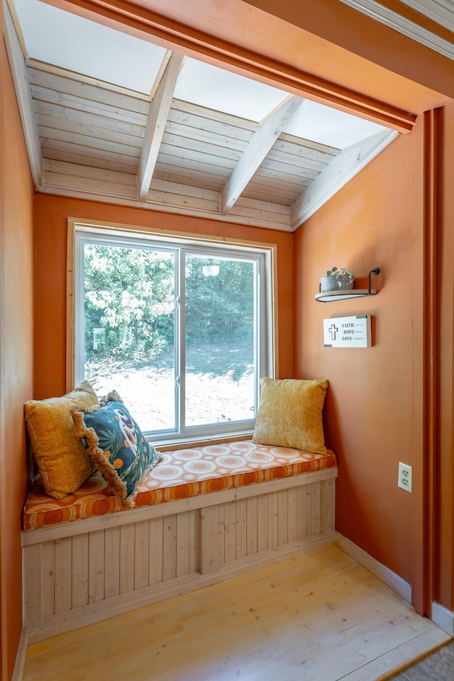 living area featuring wood ceiling, beamed ceiling, and light wood-type flooring