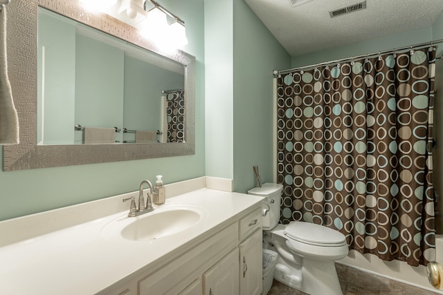 bathroom with vanity, a textured ceiling, and toilet