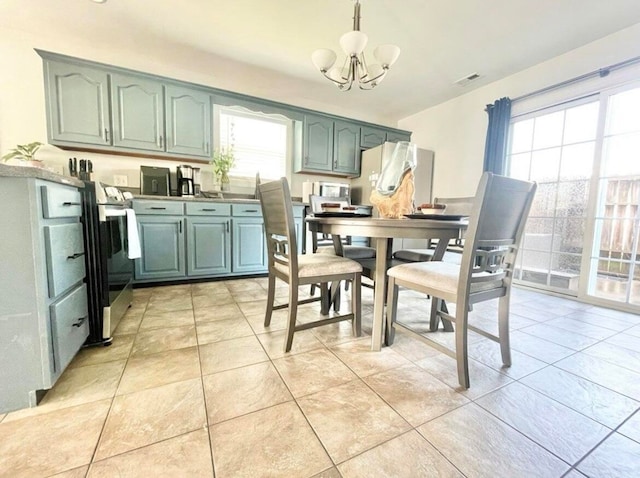 tiled dining area featuring an inviting chandelier