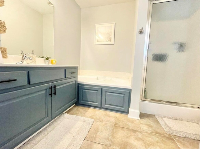 bathroom featuring vanity and independent shower and bath