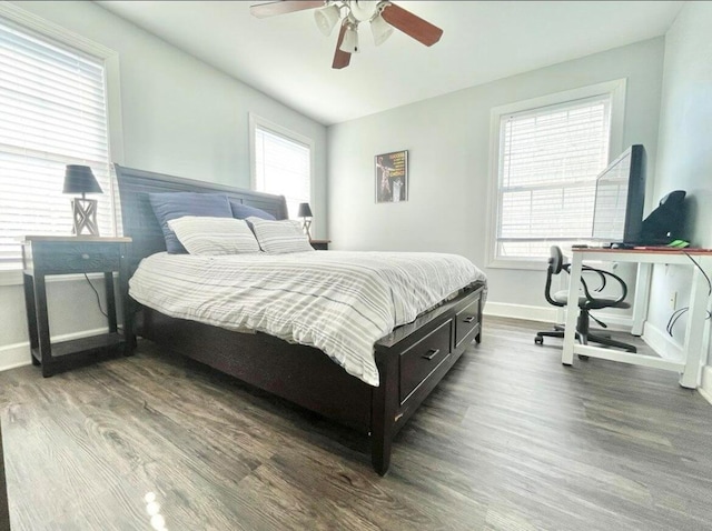 bedroom with dark hardwood / wood-style floors and ceiling fan