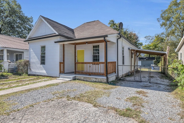 view of front facade featuring covered porch and a carport