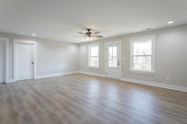 unfurnished living room with light wood-style flooring, baseboards, ceiling fan, and recessed lighting