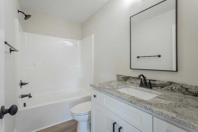 full bath featuring wood finished floors, vanity, toilet, and shower / bathtub combination