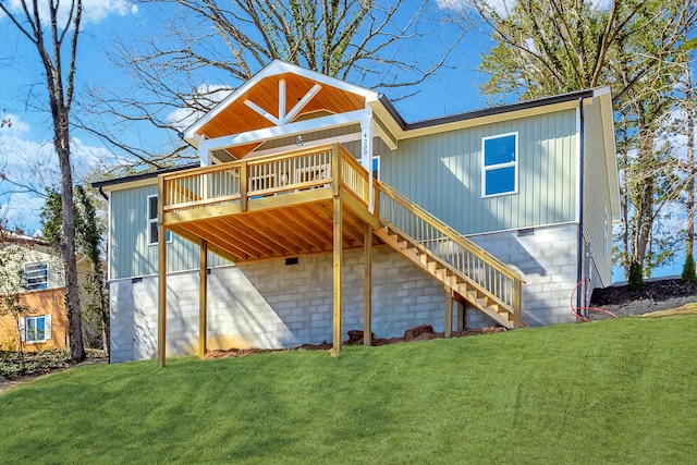 rear view of house featuring stairs, a deck, and a yard