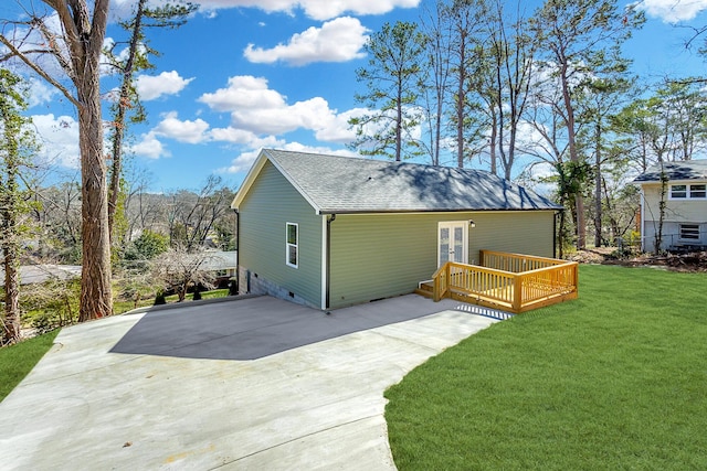 rear view of house with a shingled roof, a yard, french doors, crawl space, and a wooden deck