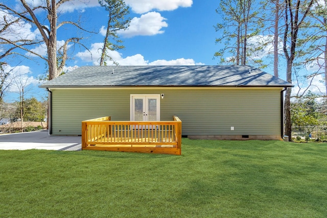 rear view of house featuring a shingled roof, a lawn, french doors, crawl space, and a wooden deck