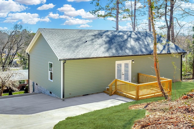 rear view of house with crawl space, french doors, roof with shingles, and a wooden deck