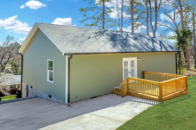 back of house featuring a yard, french doors, crawl space, roof with shingles, and a wooden deck