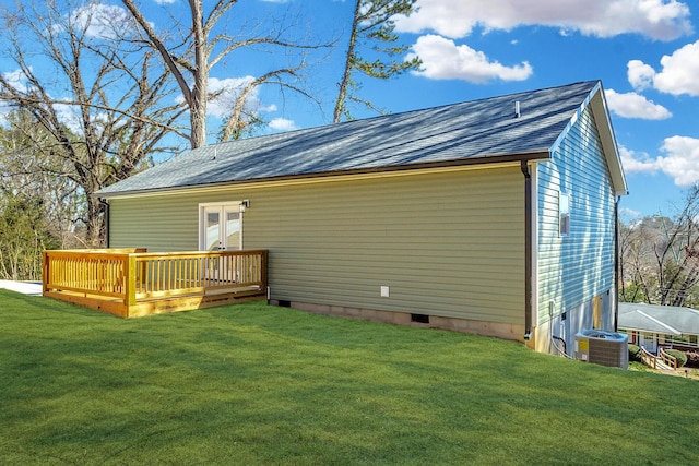 back of property featuring french doors, a lawn, a deck, and central AC unit