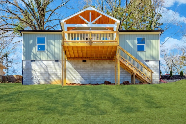 back of house with stairs, a deck, and a lawn