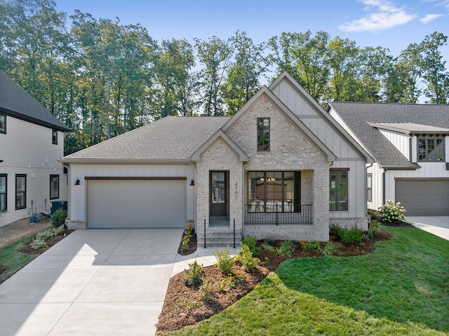 view of front of home featuring a front yard and a garage