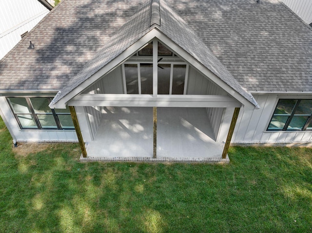 rear view of property featuring a yard