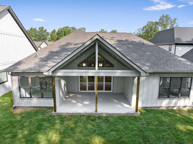 rear view of house featuring a lawn and a patio