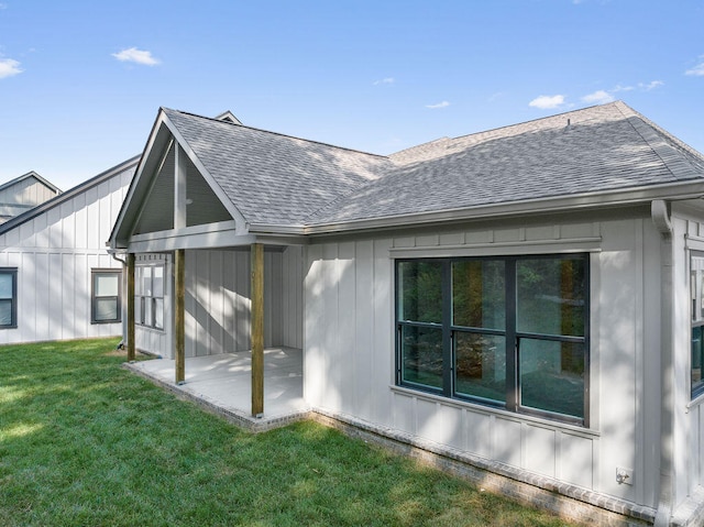 rear view of property with a patio area and a yard