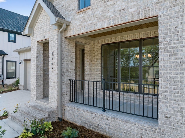 property entrance featuring a garage and covered porch